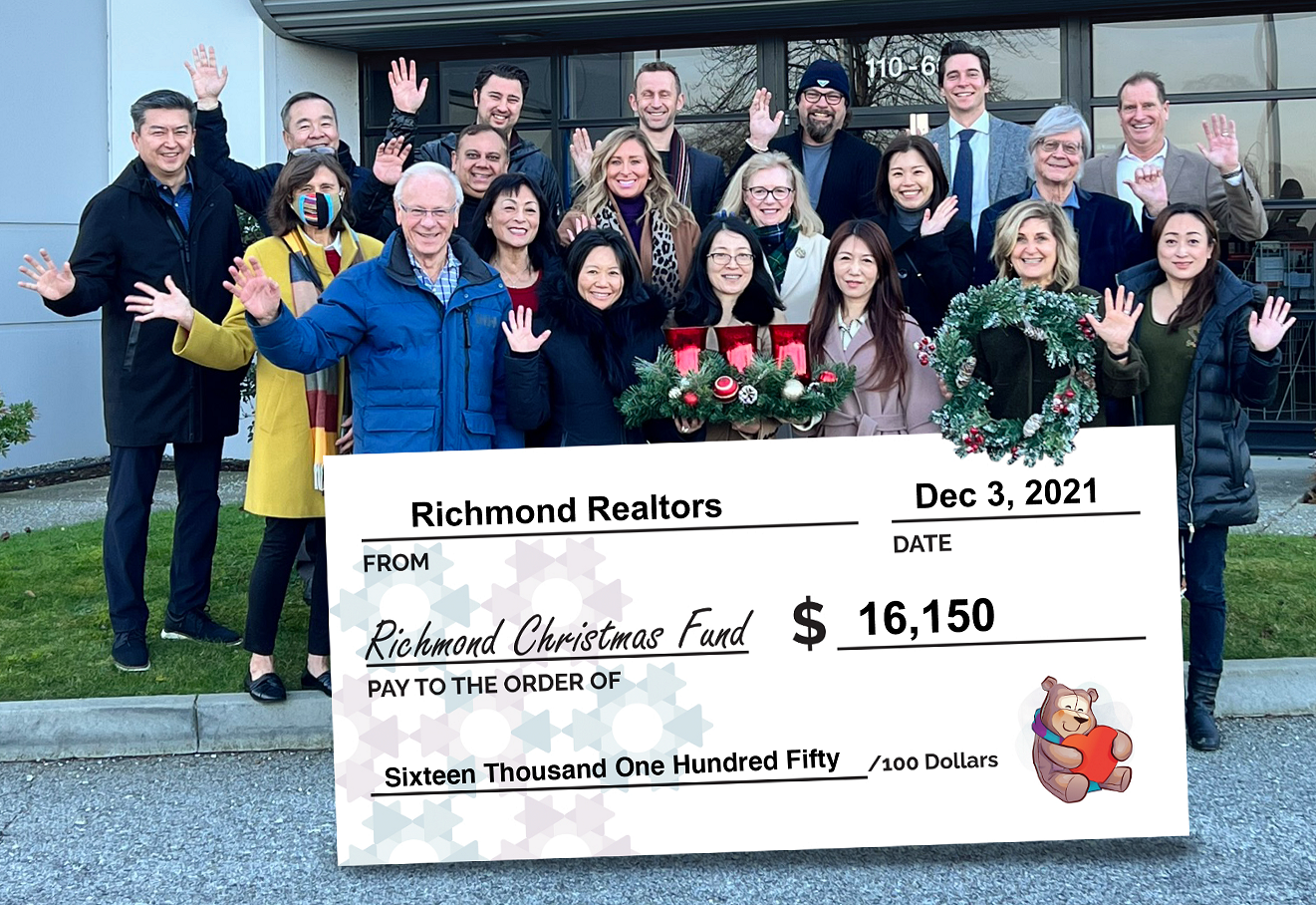 Group of Realtors Standing Behind an Oversized Cheque