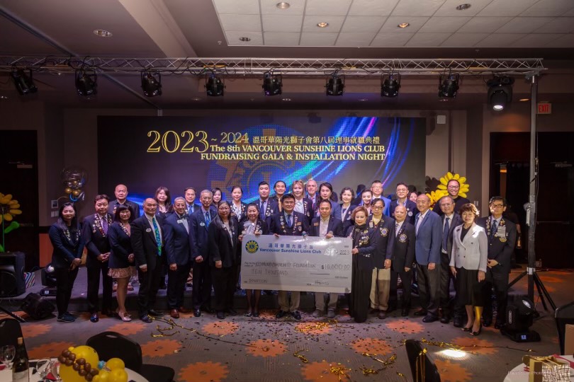 Members of the Vancouver Sunshine Lions Club posing with a large cheque