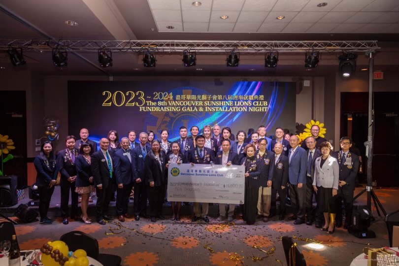 Members of the Vancouver Sunshine Lions Club posing with a large cheque