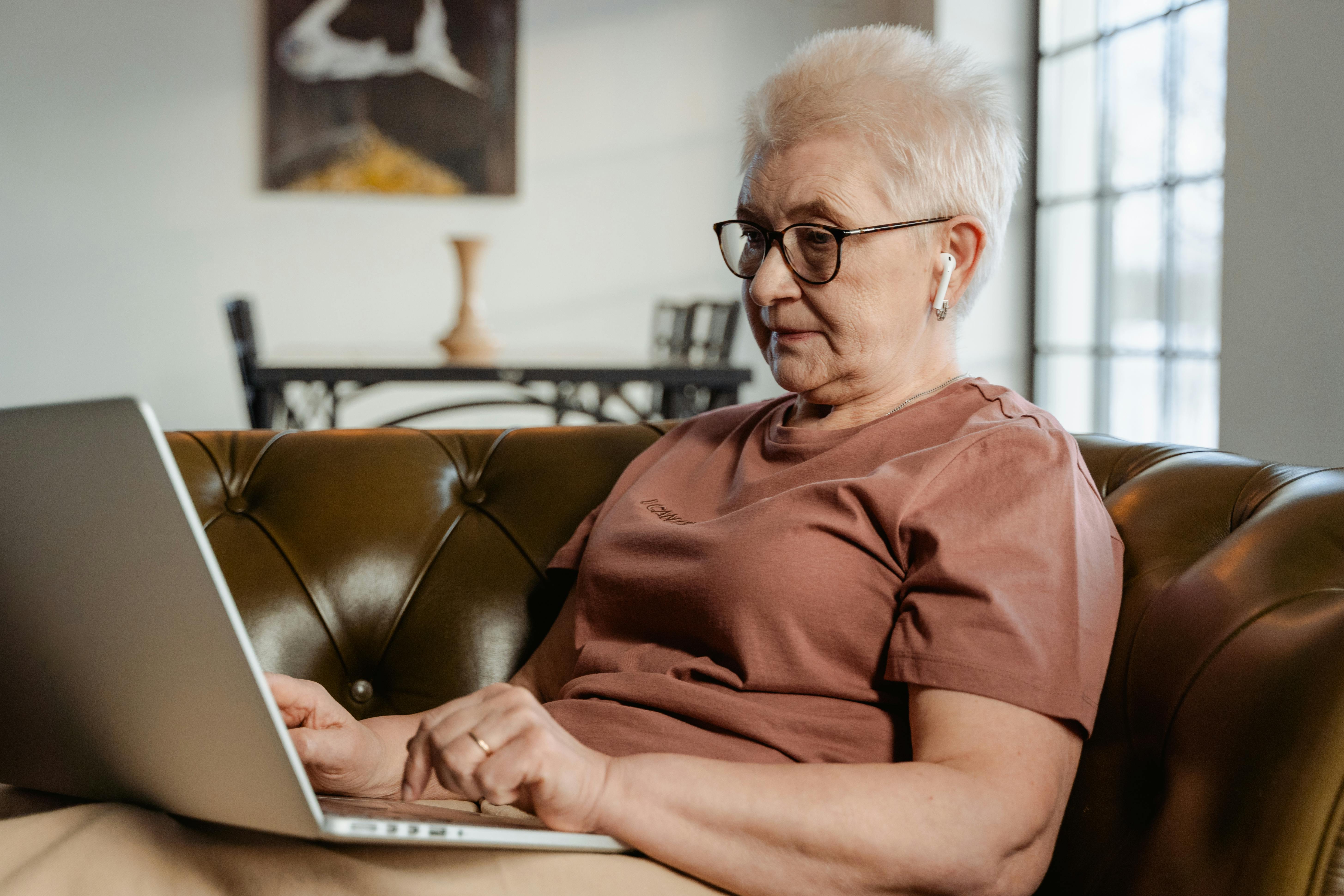 A woman in a brown shirt using a laptop