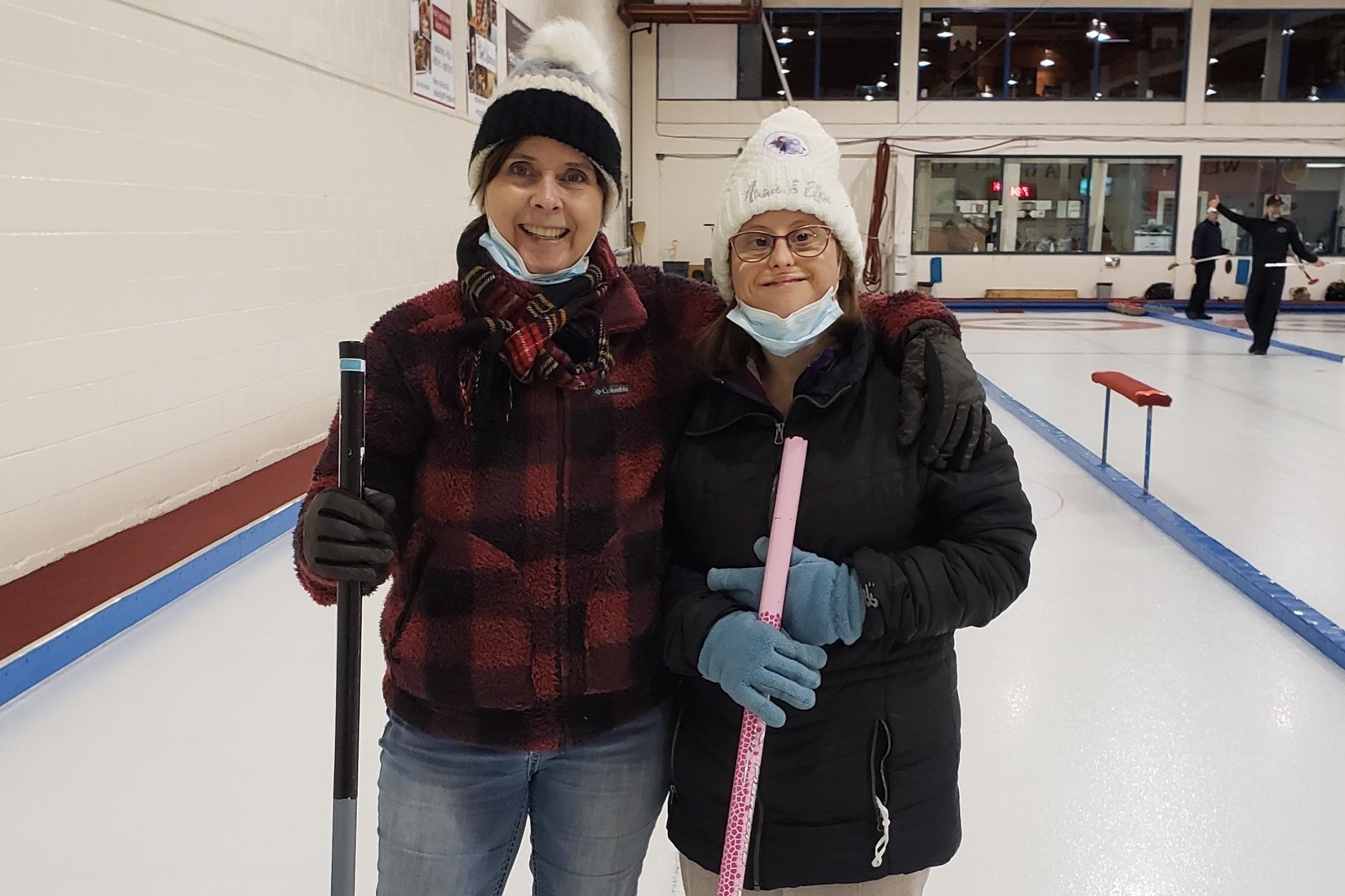 Two Women Standing on a Curling Rink