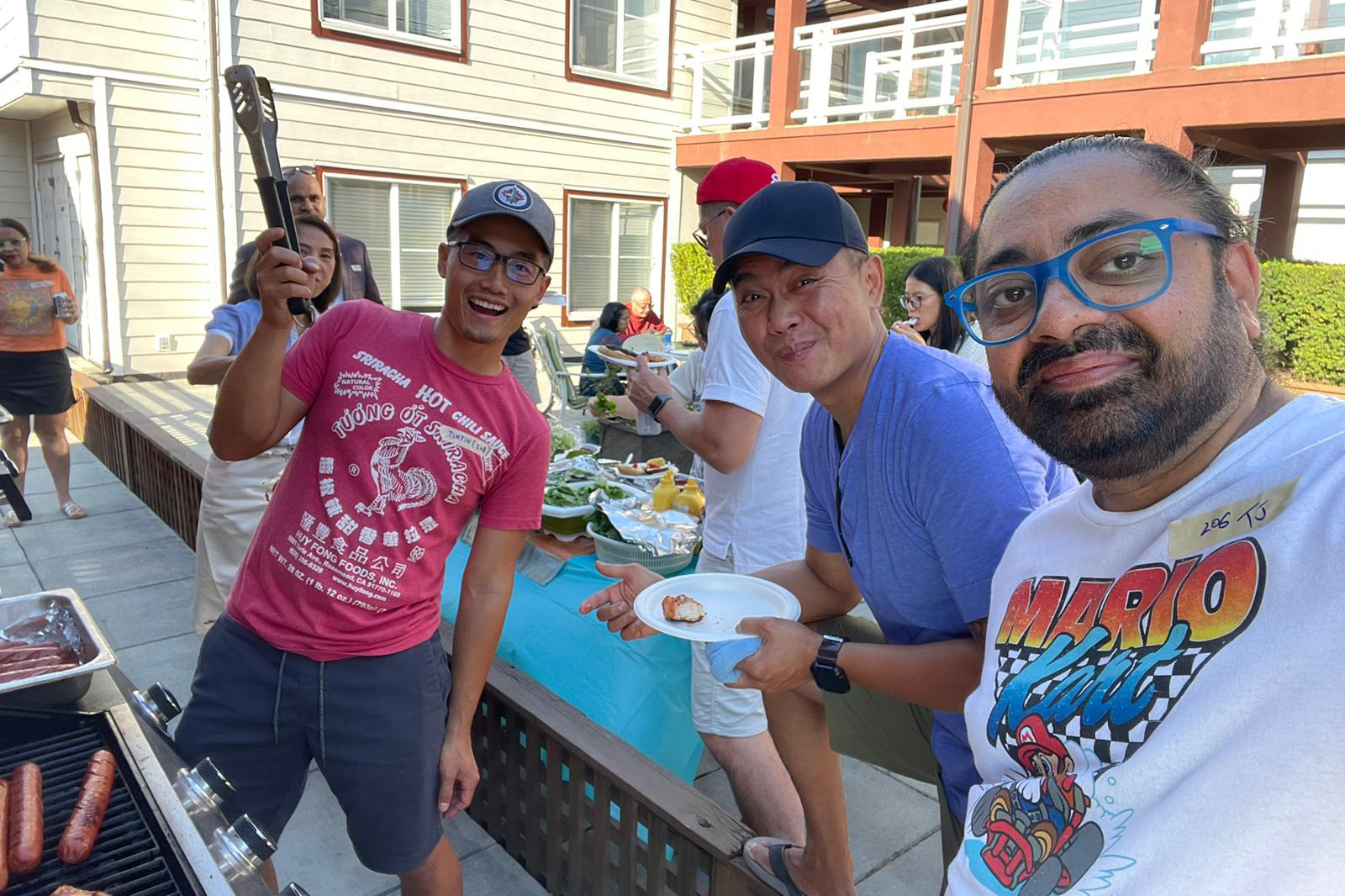 Community members taking a selfie at a BBQ